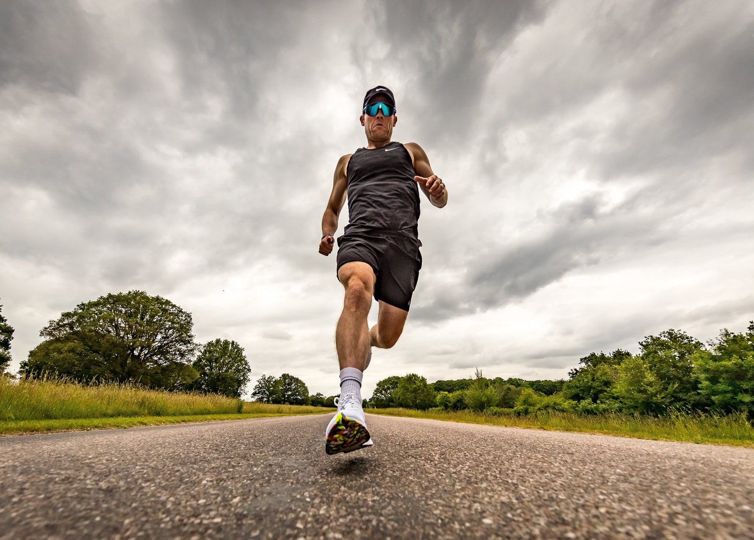 Runner stretching after marathon with water bottle and recovery snacks, focusing on post-race recovery routine