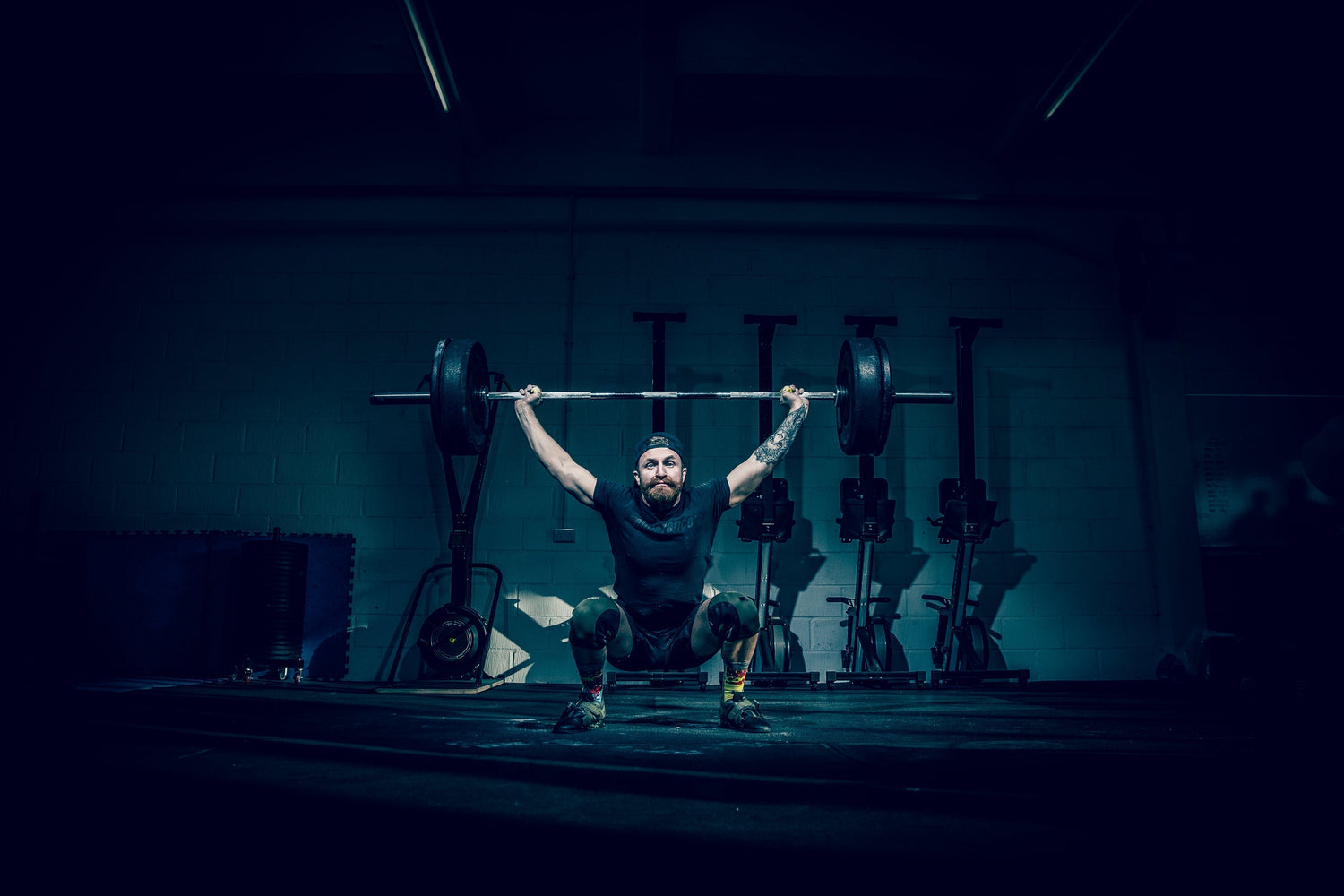 Gym goer lifting weights to build muscle and strength.