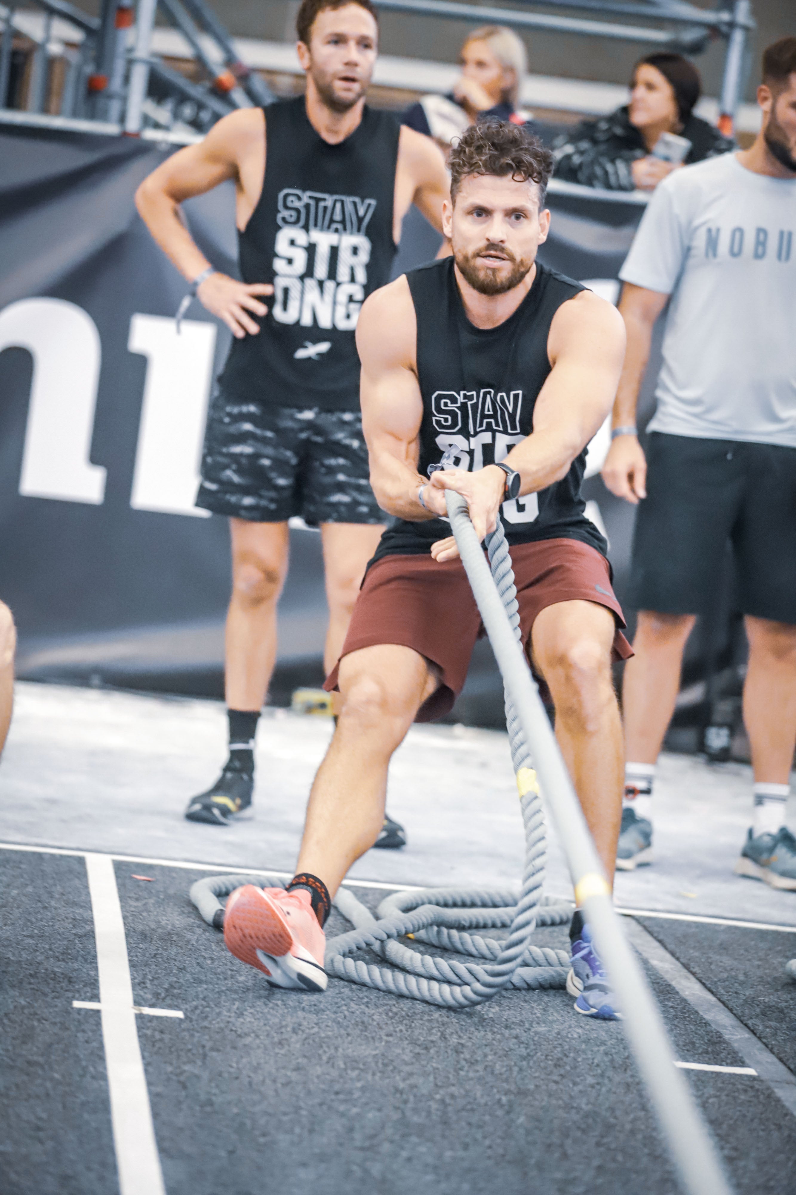 Athlete training with sled pull Hyrox → “Hyrox athlete pulling sled with Xendurance Lactic Acid Buffer support”